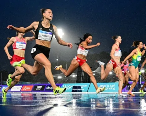 New Zealand's Zoe Hobbs (left) crosses the finish line to win the women's 100m final
