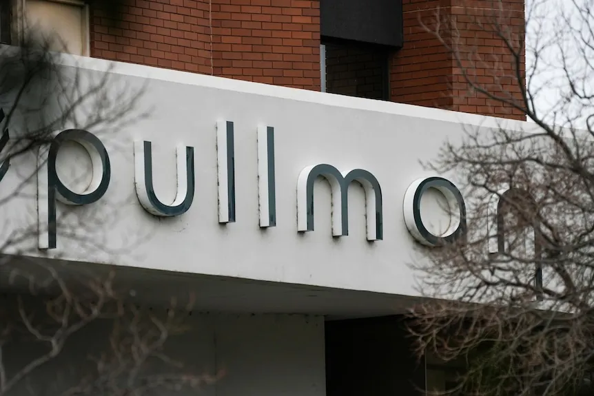 The outside of the Pullman hotel, with a sign visible.